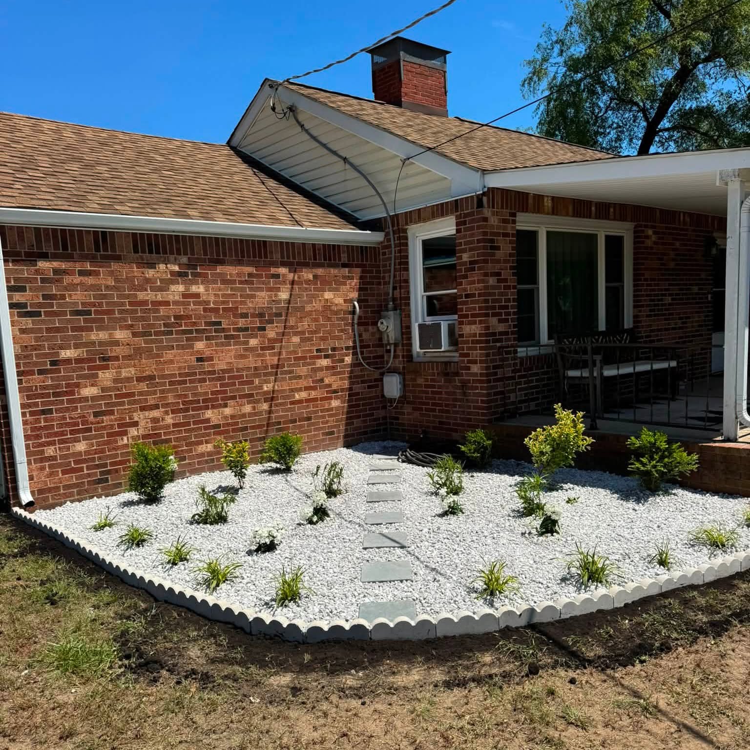Finished white-stone landscape bed at a residence